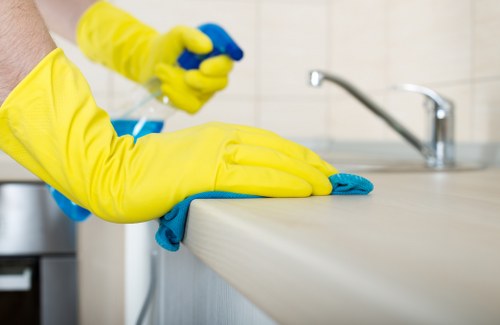 Cleaner using protective equipment while beginning a safe cleaning task