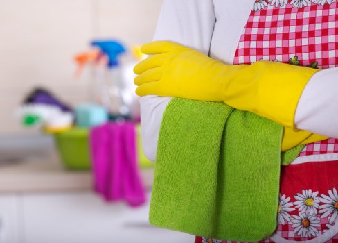 Technician cleaning oven racks in Wimbledon